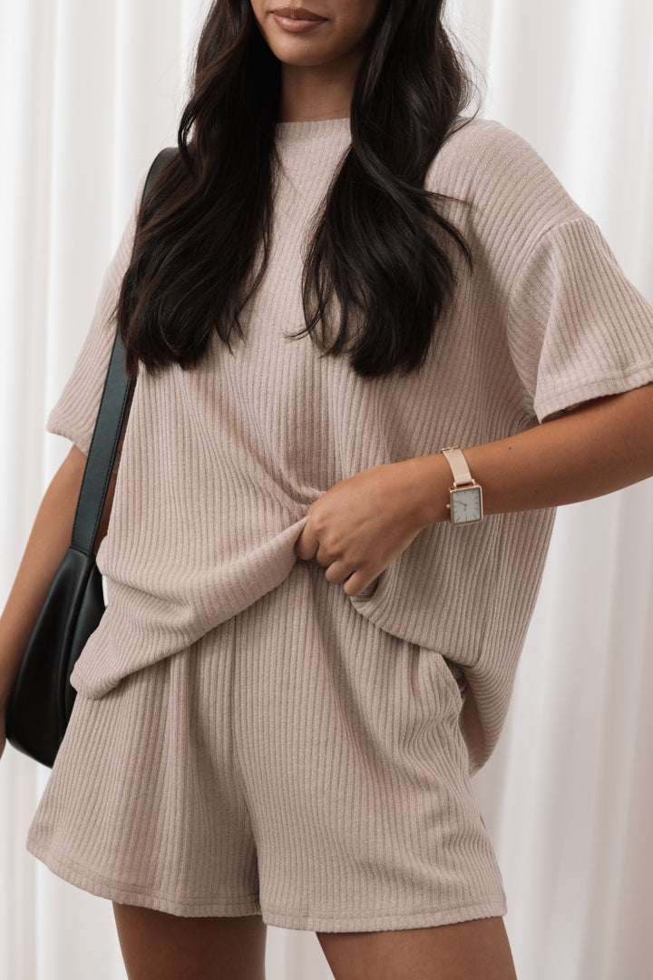 A woman wearing a tan loungewear set